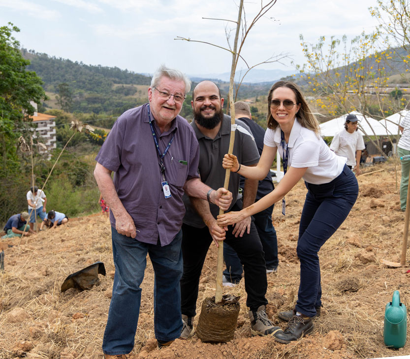 Foto com Gilberto Natalini, (Coordenador de Meio Ambiente); Roberto Alves Soares (Analista Ambiental) e Vivian Heller Weiss Souguellis (Engenheira Ambiental) plantando uma muda de árvore na unidade de lazer Serra Negra.